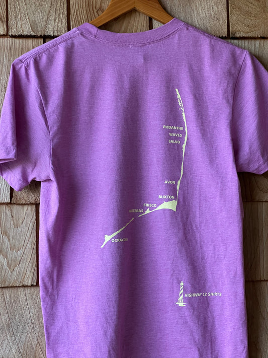 Purple shirt with green text and graphics on a wooden surface