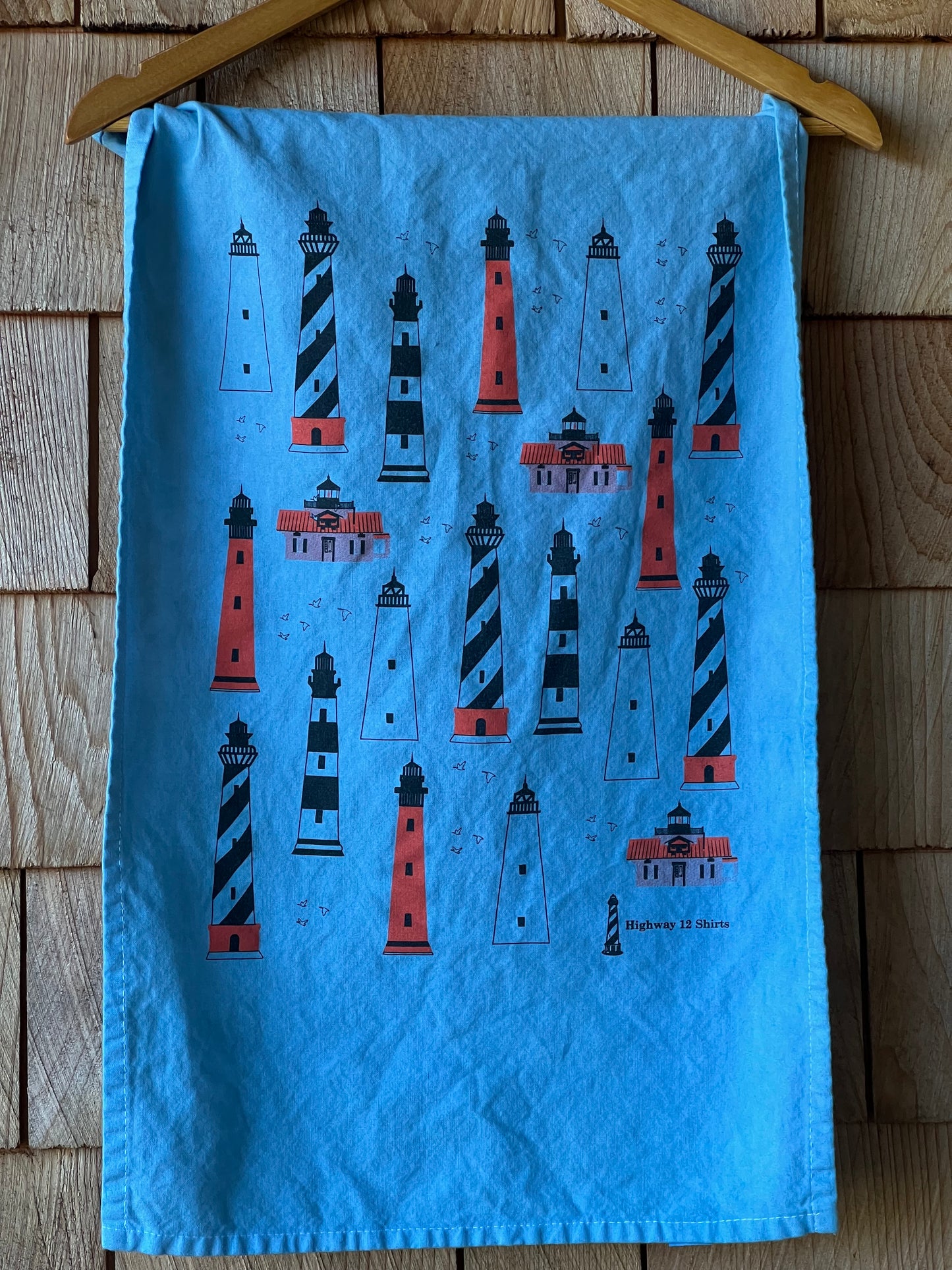 Blue fabric with lighthouse pattern on a wooden surface