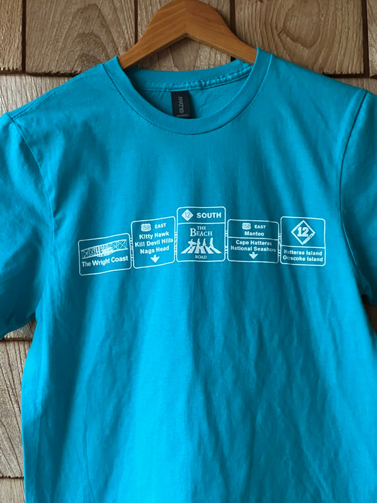 Blue t-shirt with brand logos on a wooden surface