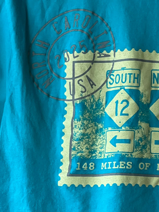 Close-up of a blue and gold road sign with a stamp on a blue background