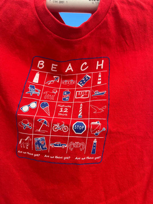Red shirt with beach-themed graphic design on a blue background