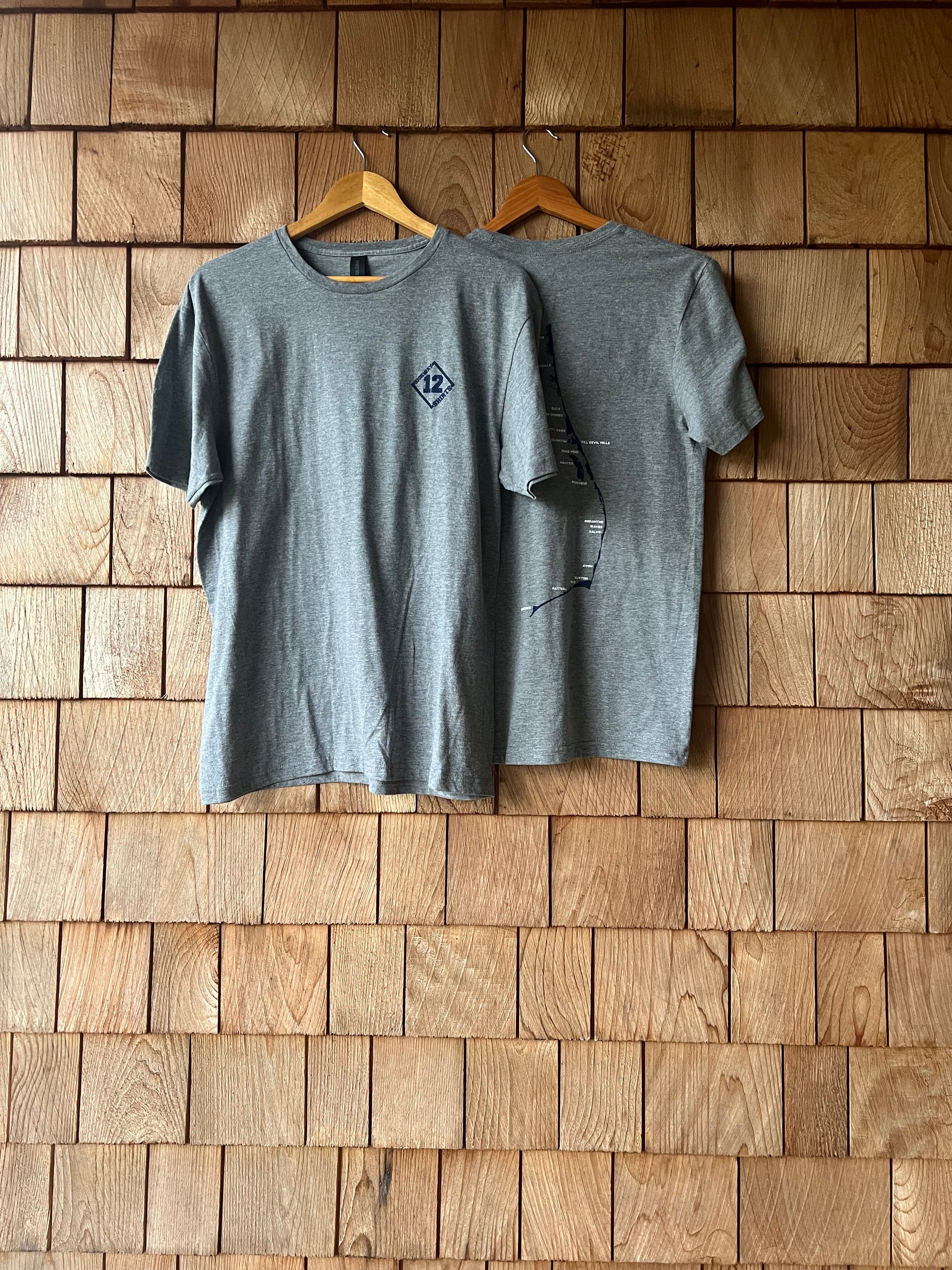 Gray t-shirt on a wooden wall