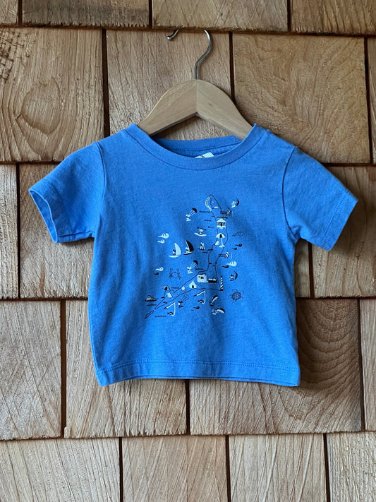 Blue t-shirt with a design on a wooden surface