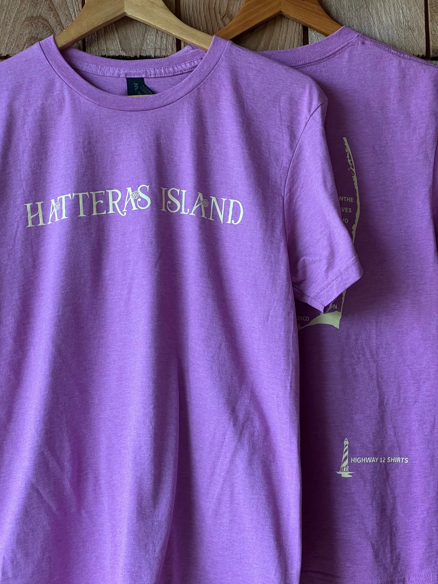Purple shirt with 'Hatteras Island' text on a wooden surface