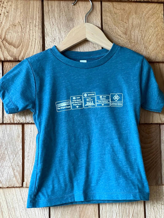 Blue t-shirt with printed design on a wooden surface