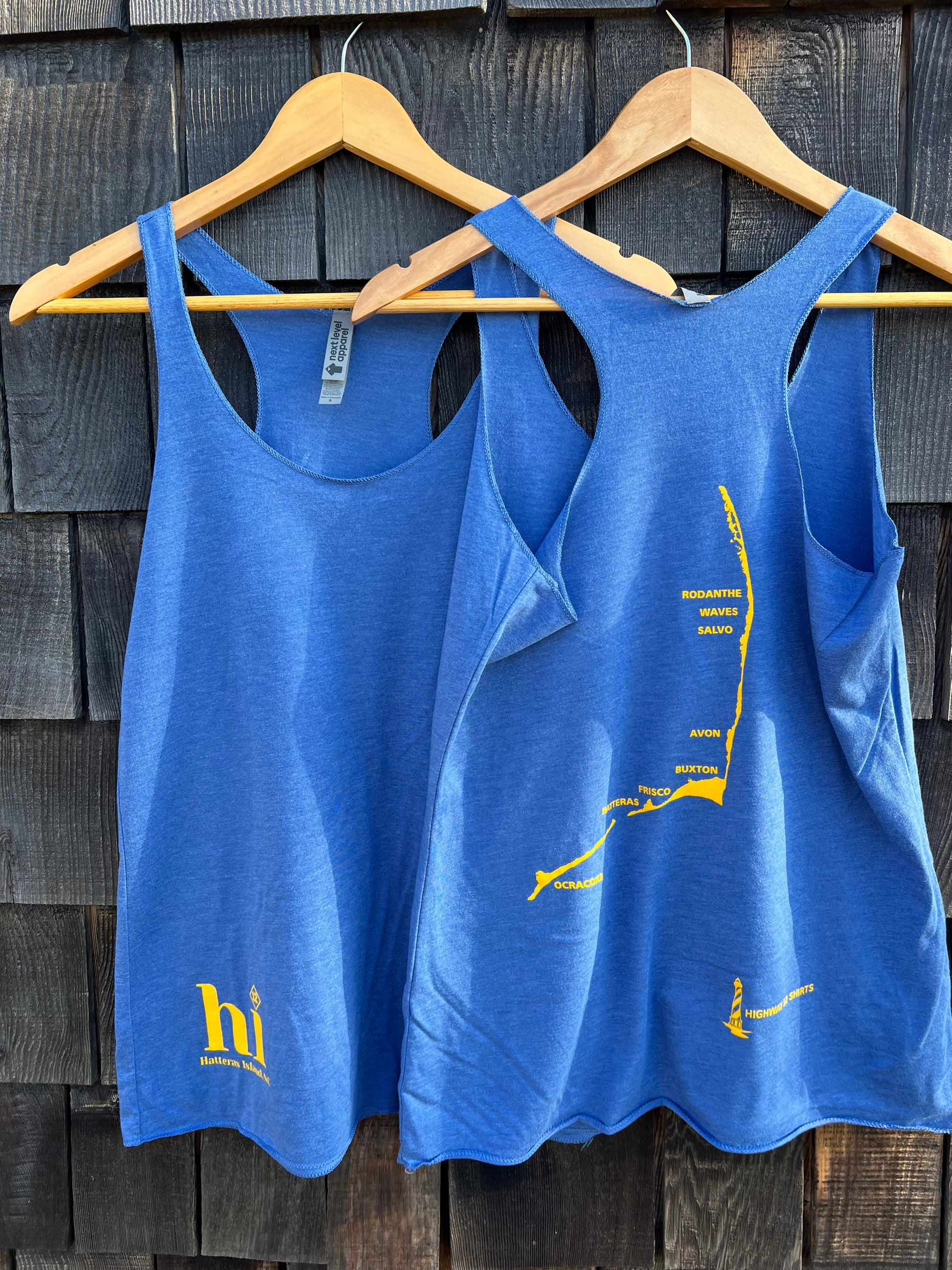 Blue tank top with yellow text and logo on a wooden surface