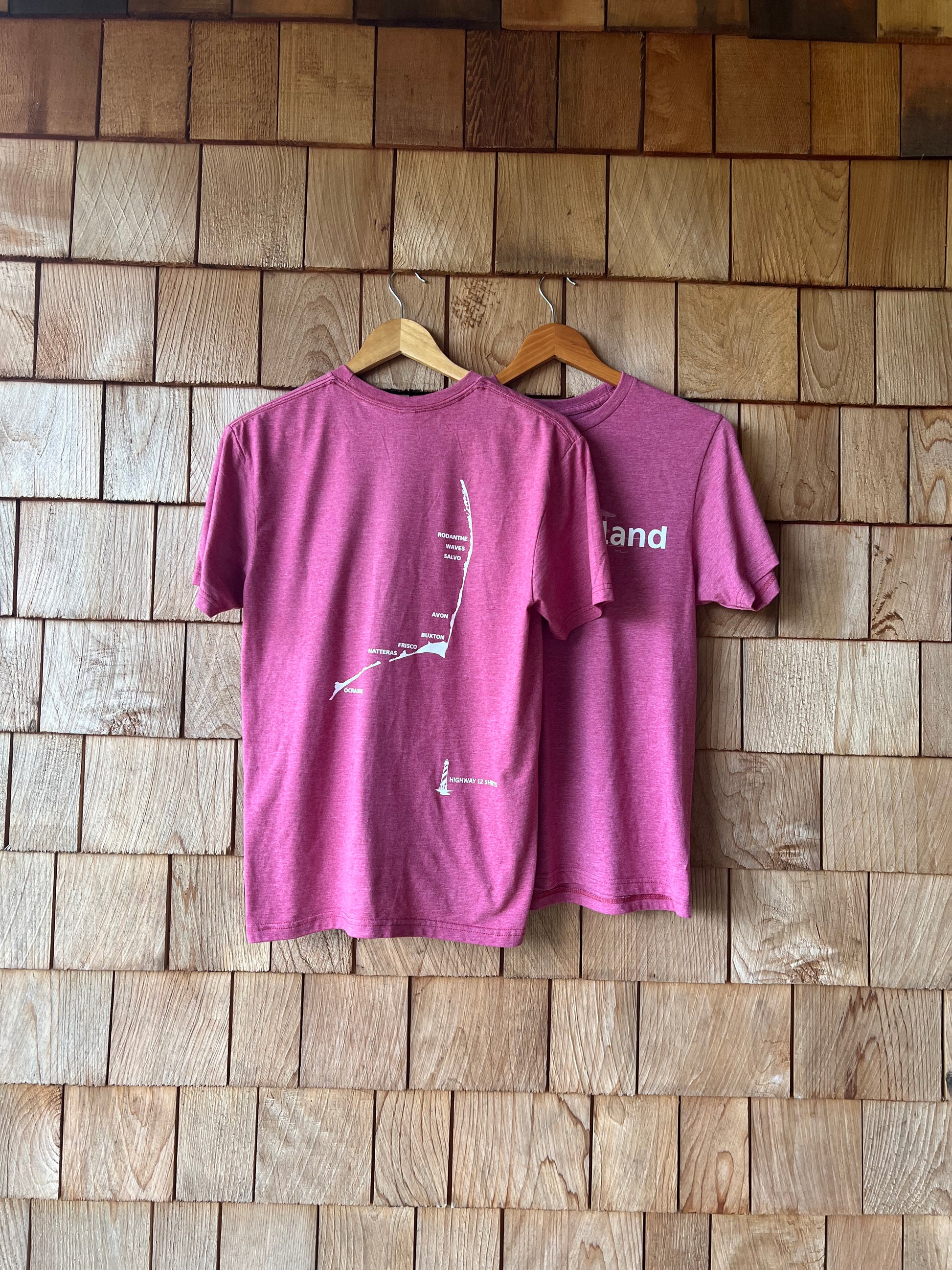 Purple t-shirt with white text on a wooden floor