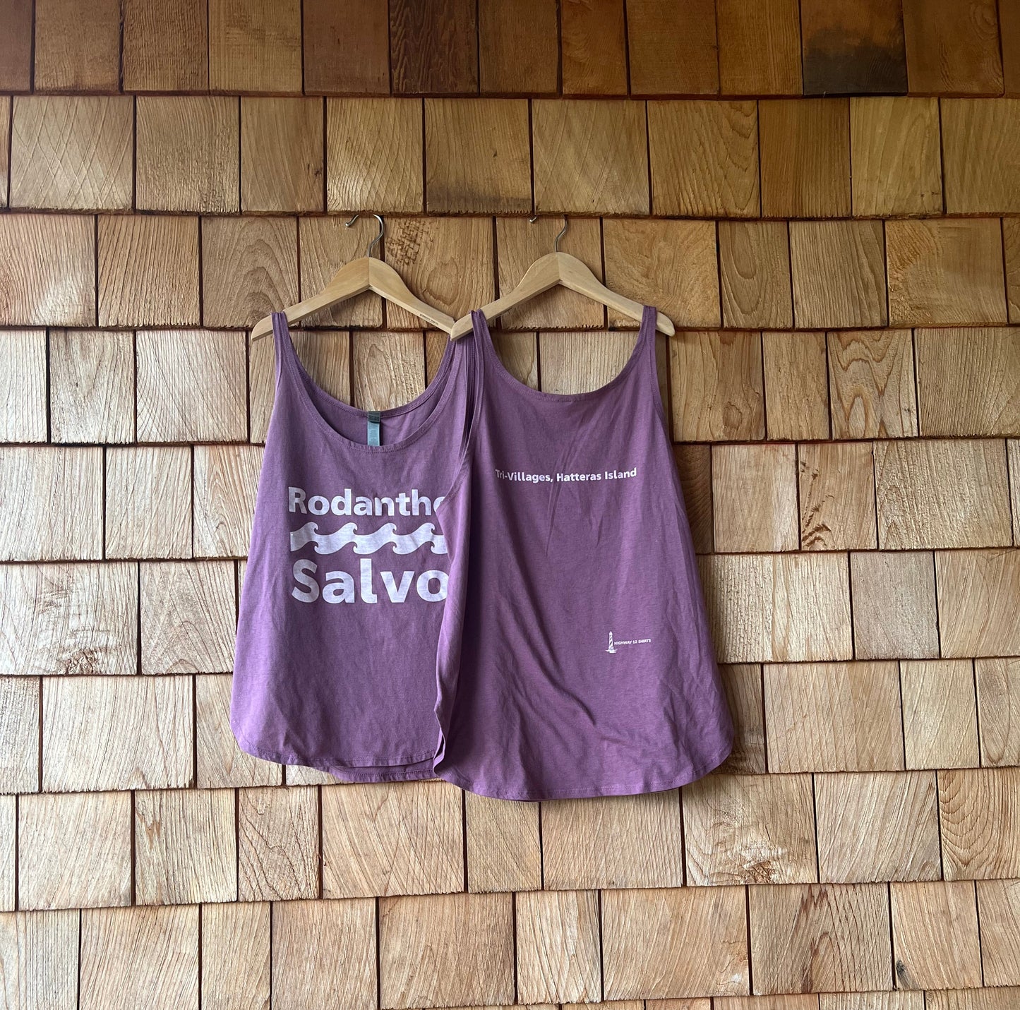 Purple tank top with text on a wooden floor