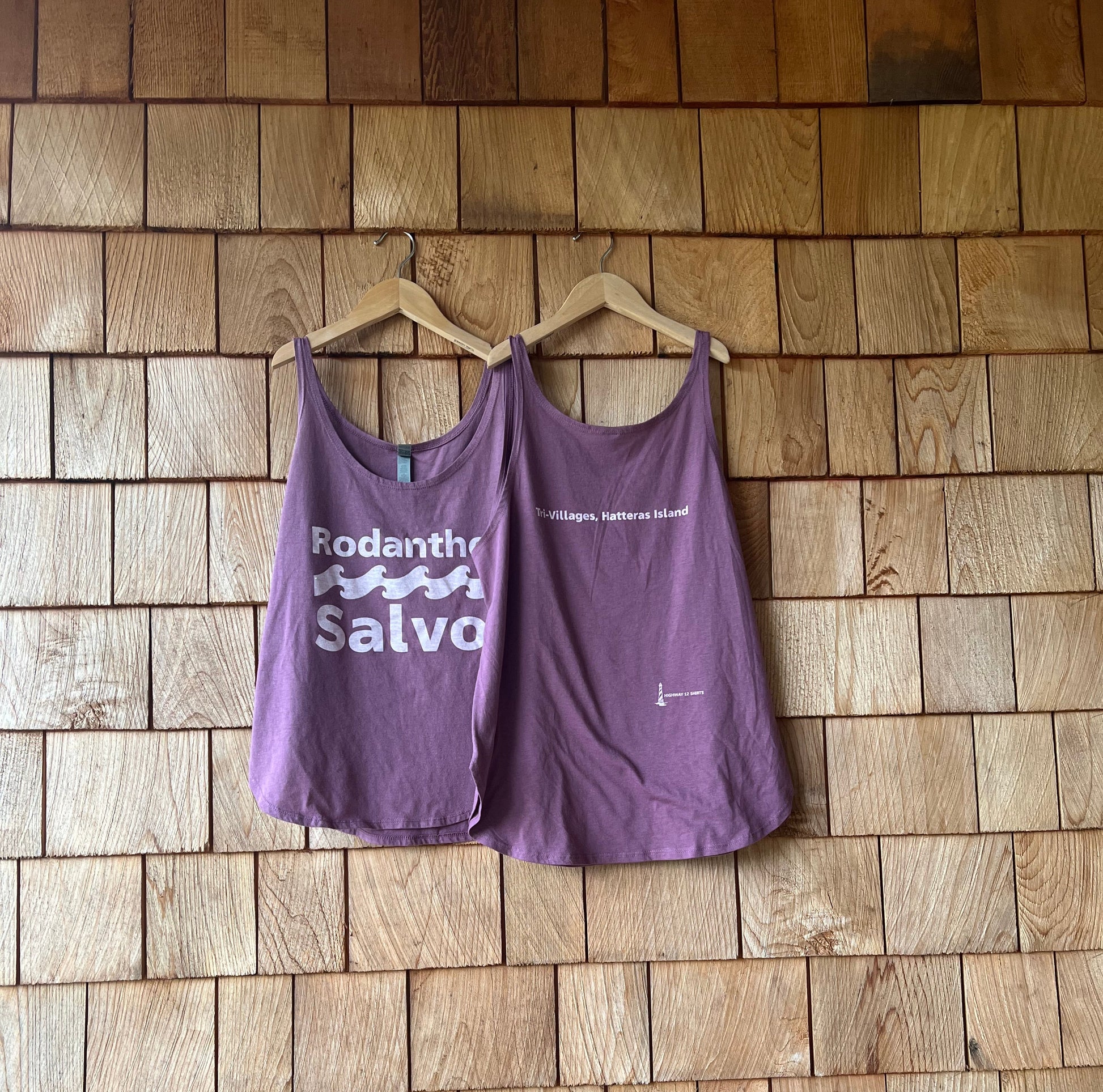 Purple tank top with text on a wooden floor