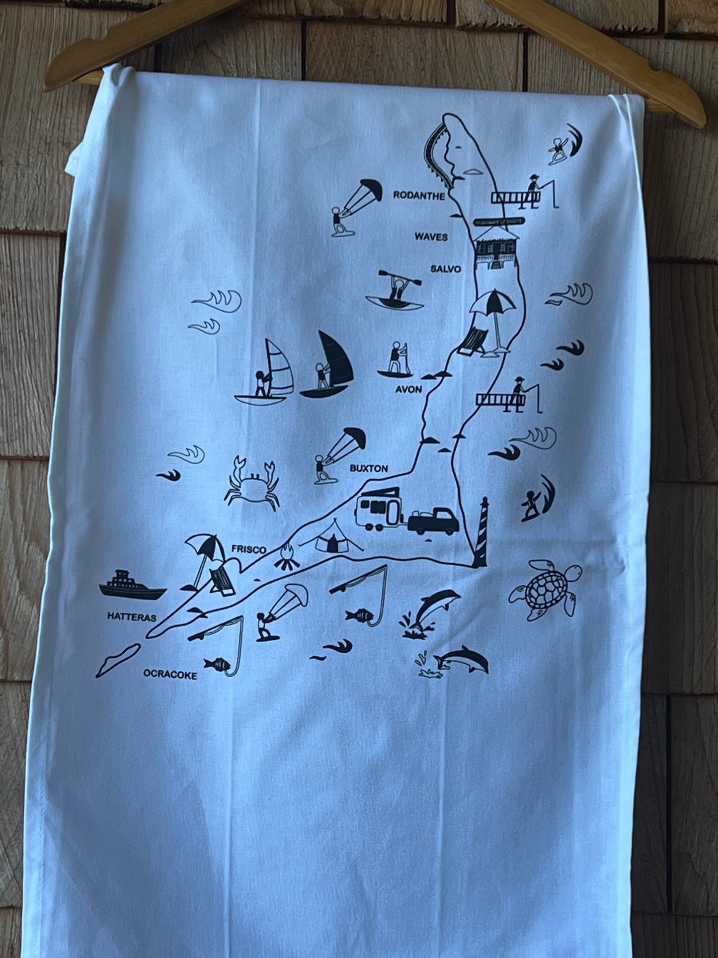 White towel with black map design on a wooden surface