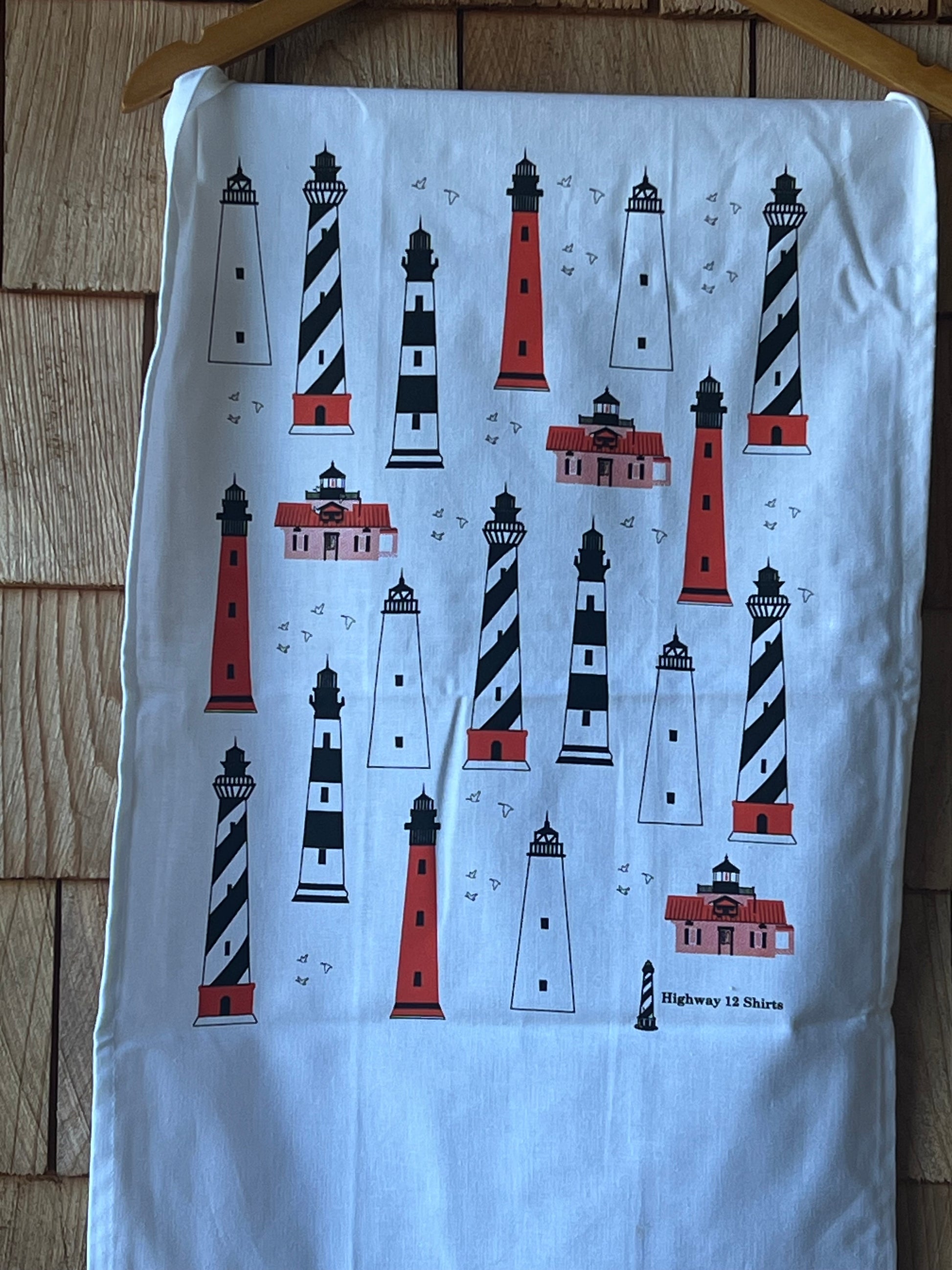 Fabric with lighthouse pattern on a wooden surface