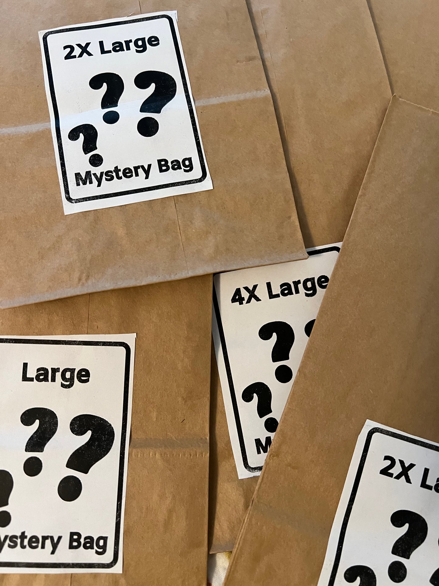 Mystery bag labels with question marks on a brown paper bag background