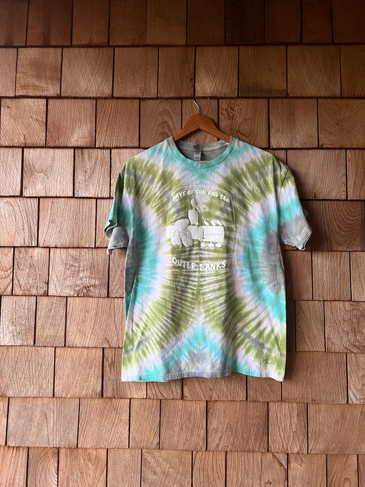 Tie-dye shirt with text on a wooden wall
