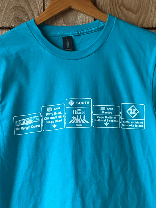 Blue t-shirt with white graphics on a wooden surface