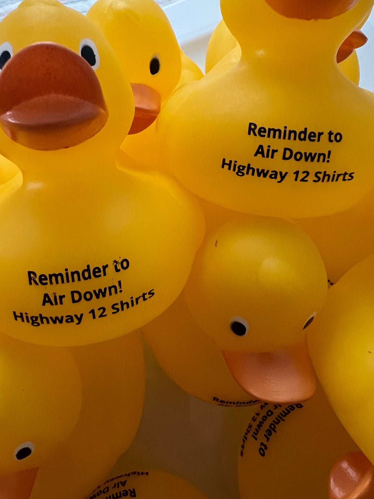 Yellow rubber ducks with text on a white background