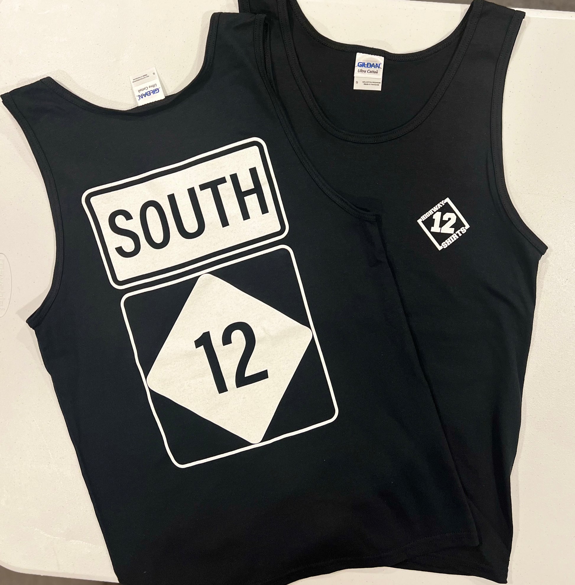 Black tank top with 'SOUTH' and number '12' design on a white background