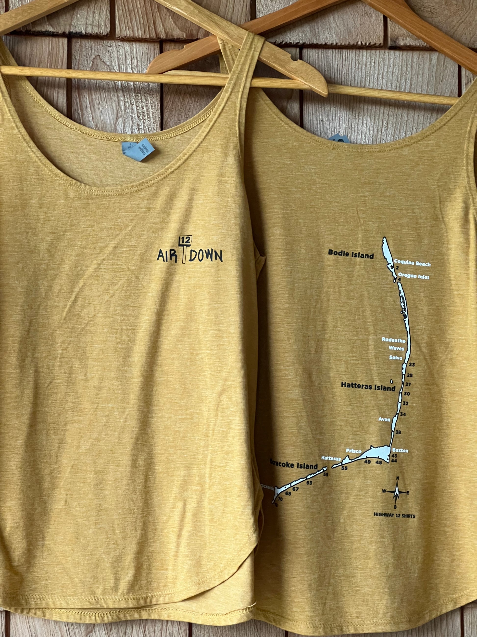 Yellow tank top with a map design on a wooden surface