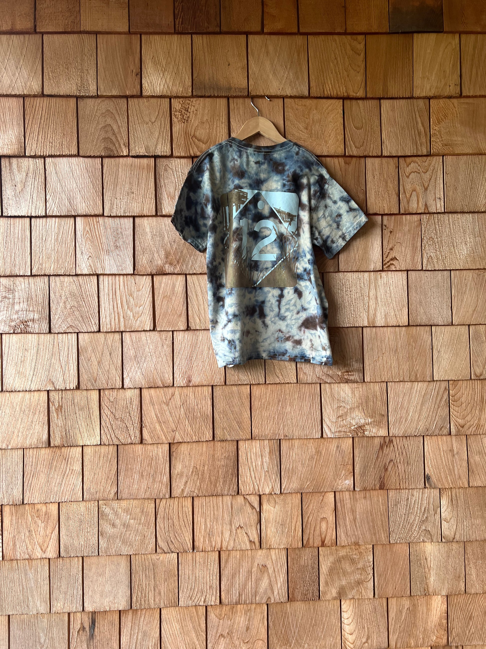 camo-patterned shirt on a wooden floor
